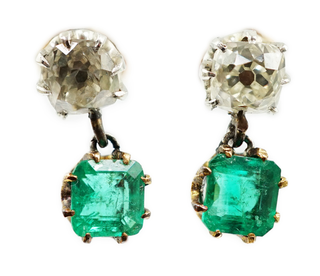 A pair of late 19th/early 20th century gold and platinum, emerald and diamond set two stone drop earrings